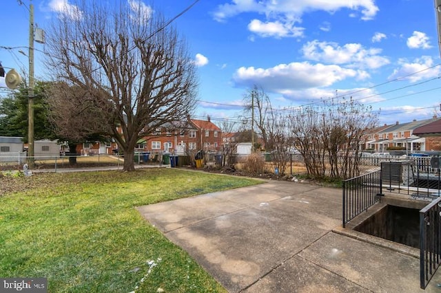 surrounding community with a yard, fence, and a residential view