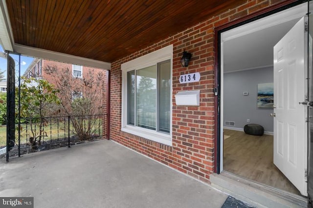 view of patio / terrace featuring a porch and visible vents