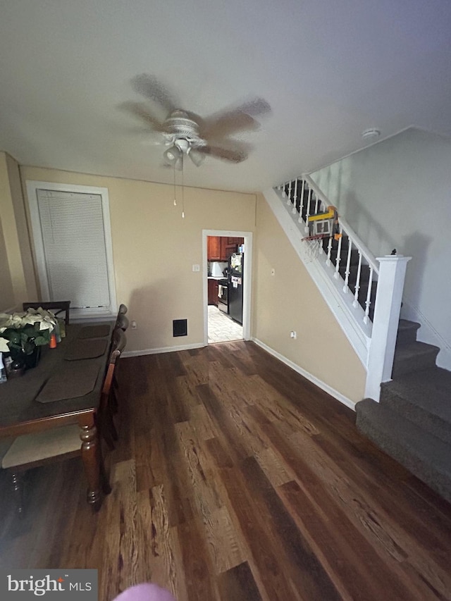 dining area featuring dark wood-type flooring and ceiling fan