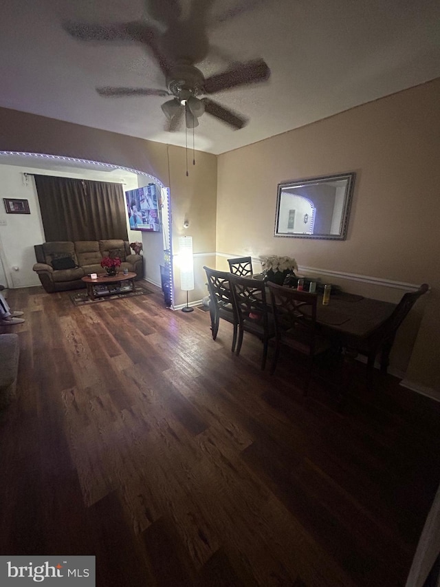 dining room with dark hardwood / wood-style flooring and ceiling fan