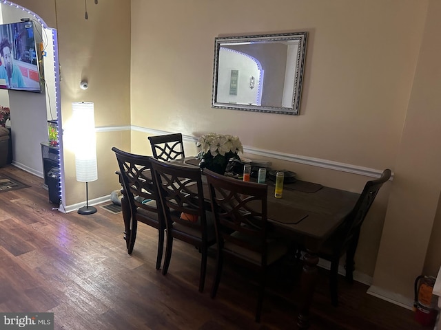 dining space with dark hardwood / wood-style flooring