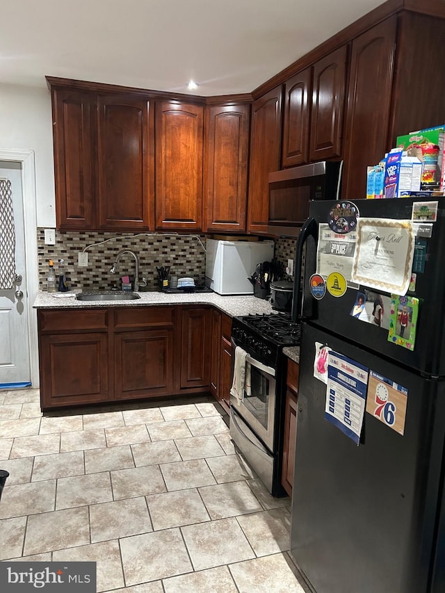 kitchen featuring sink, backsplash, and stainless steel appliances