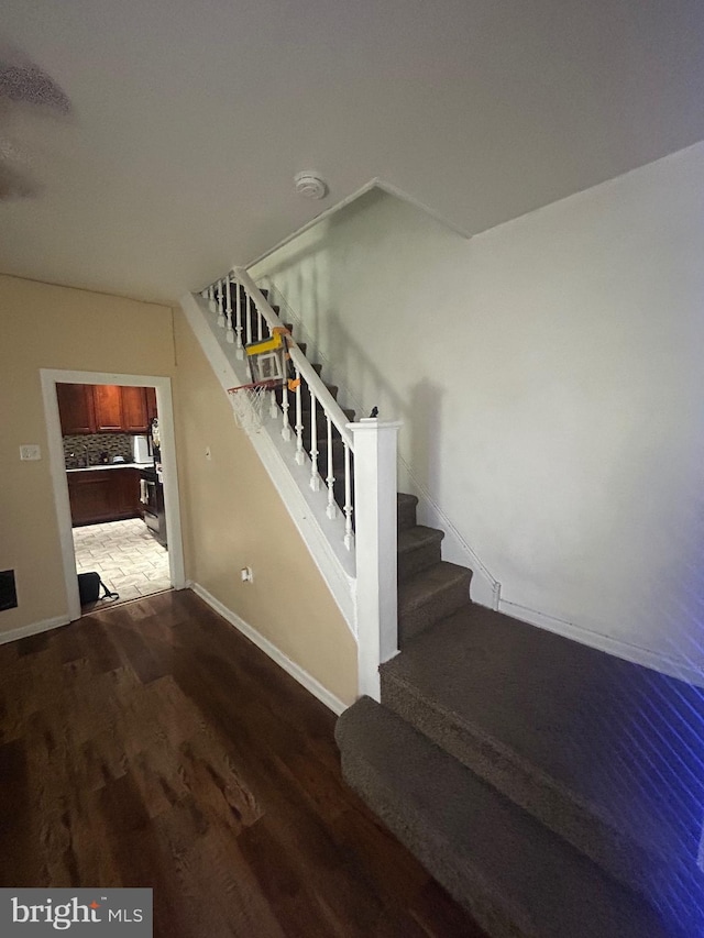 stairs with hardwood / wood-style flooring