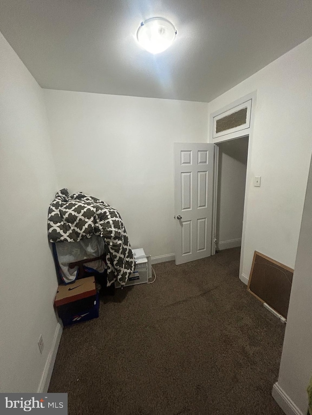 misc room with dark colored carpet