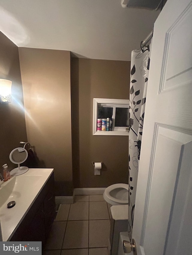 bathroom featuring vanity, tile patterned floors, and toilet