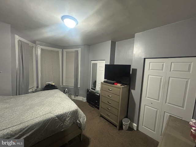 bedroom featuring dark carpet