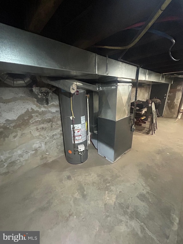 utility room featuring heating unit and water heater