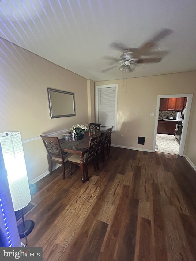 dining area featuring ceiling fan and dark hardwood / wood-style flooring