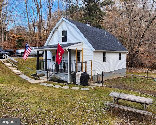 exterior space with covered porch and a front yard