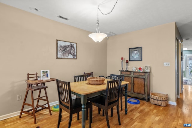 dining area with light hardwood / wood-style floors