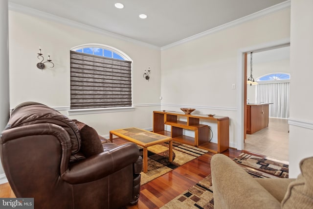 living room with crown molding and light hardwood / wood-style floors