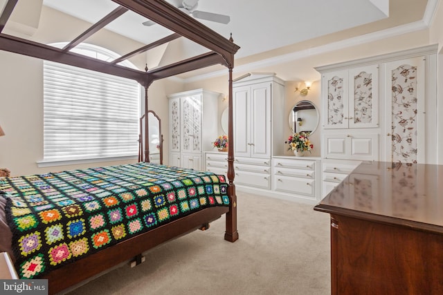 carpeted bedroom with ceiling fan and ornamental molding