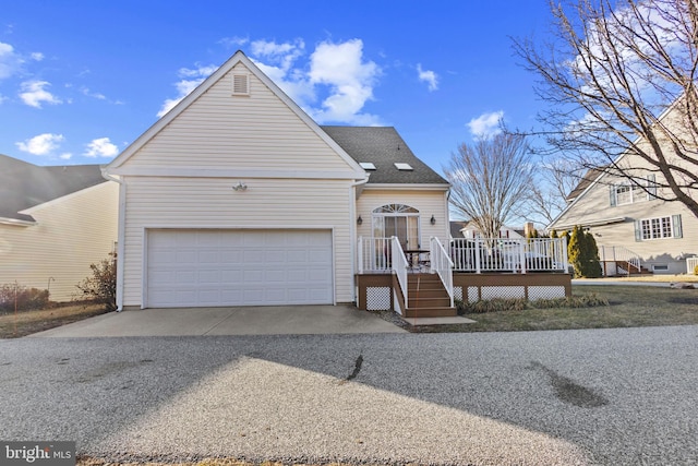 view of front of house with a wooden deck and a garage