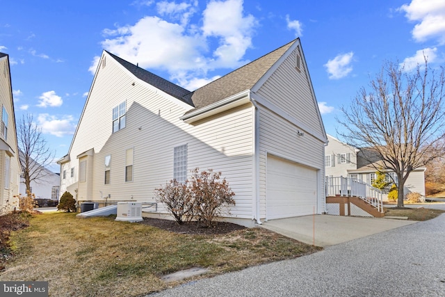 view of property exterior featuring a yard and a garage