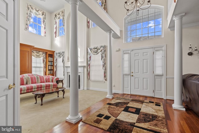 foyer featuring plenty of natural light and decorative columns