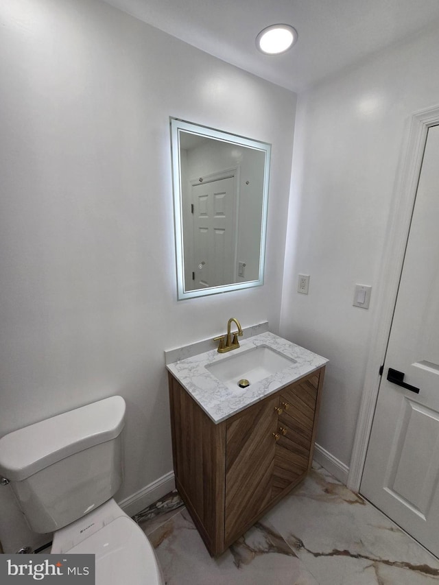 bathroom with vanity and toilet