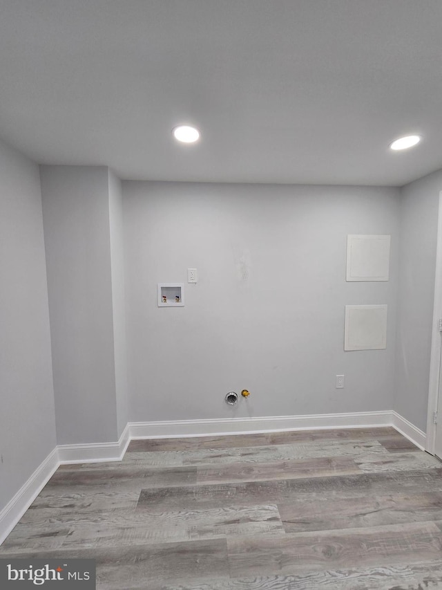 laundry room featuring gas dryer hookup, hookup for a washing machine, and light hardwood / wood-style flooring