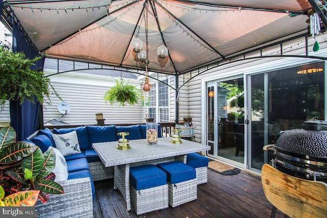 wooden terrace featuring a gazebo and an outdoor hangout area