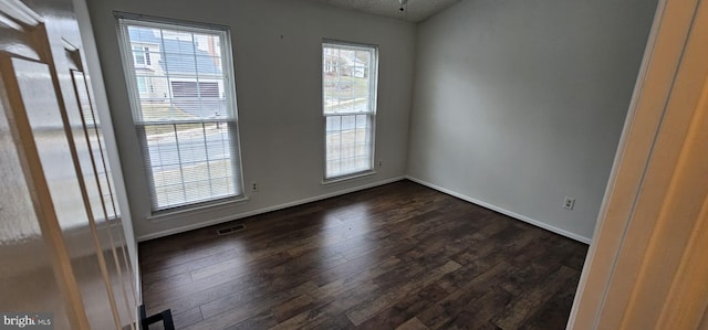 empty room with dark wood-type flooring