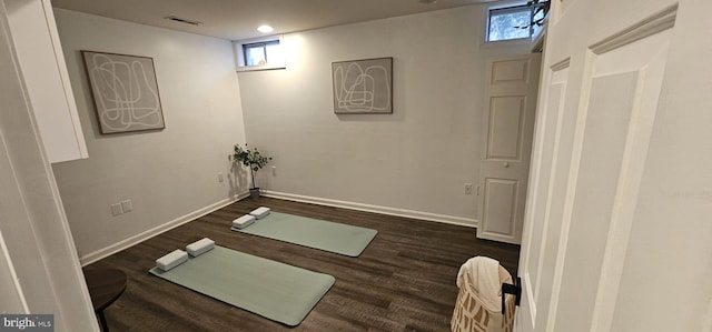 workout room with plenty of natural light and dark hardwood / wood-style floors