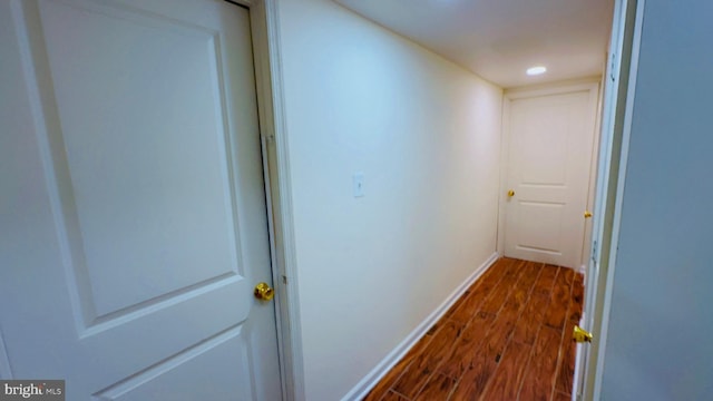 corridor featuring dark hardwood / wood-style floors