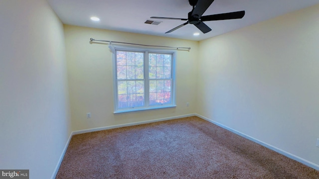 carpeted empty room featuring ceiling fan