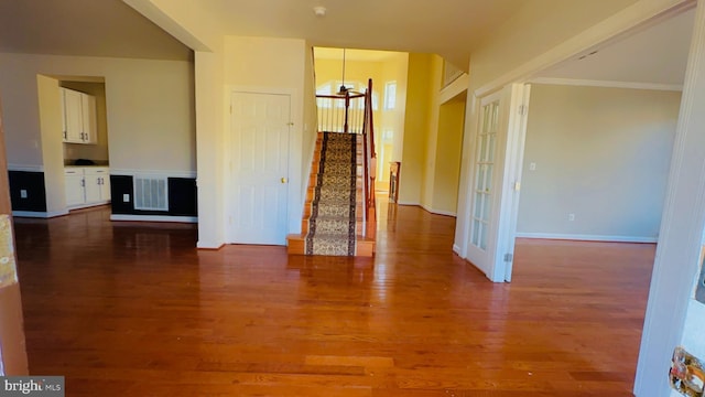 spare room with crown molding and hardwood / wood-style floors