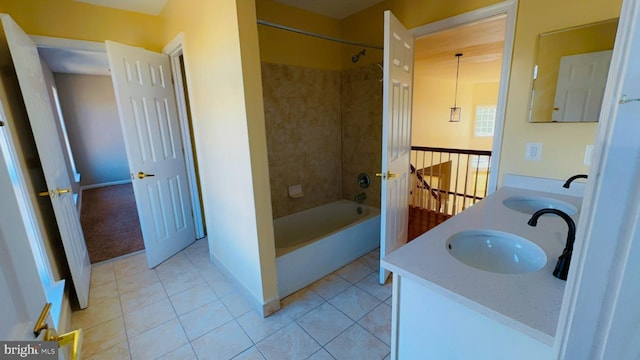 bathroom with tiled shower / bath, vanity, and tile patterned flooring