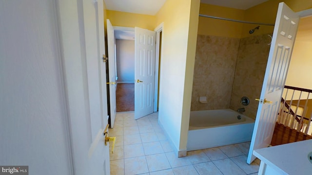 bathroom with tiled shower / bath, tile patterned floors, and vanity