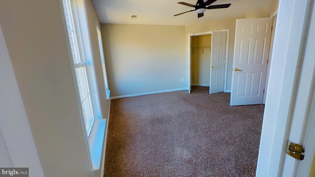 unfurnished bedroom with carpet, ceiling fan, and a closet