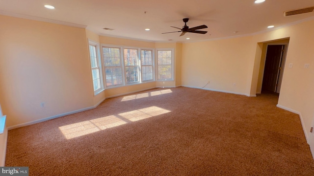 spare room with light carpet, crown molding, and ceiling fan