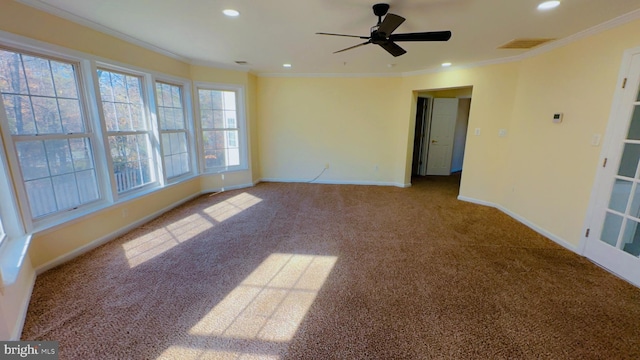 carpeted spare room featuring crown molding