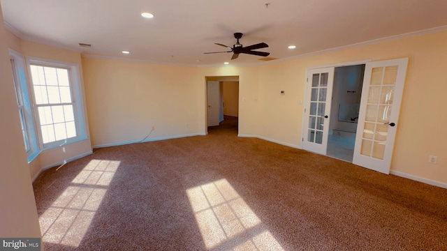 carpeted spare room featuring crown molding, french doors, and ceiling fan