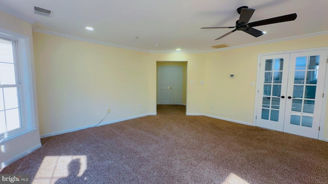 unfurnished room with french doors, ornamental molding, carpet flooring, and plenty of natural light