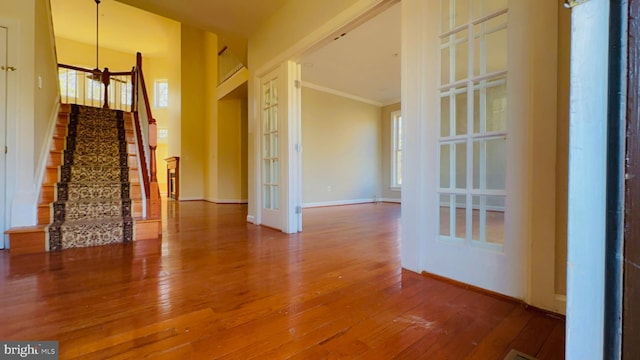 spare room featuring hardwood / wood-style flooring and crown molding