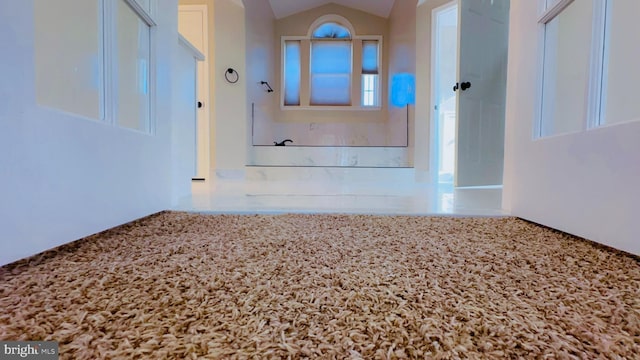 hallway featuring vaulted ceiling