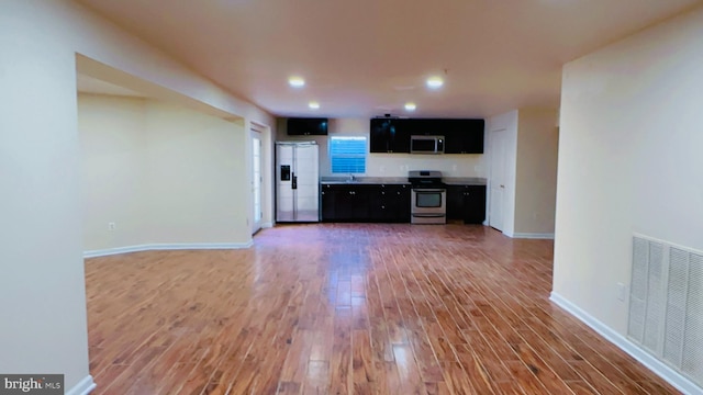 unfurnished living room with hardwood / wood-style flooring