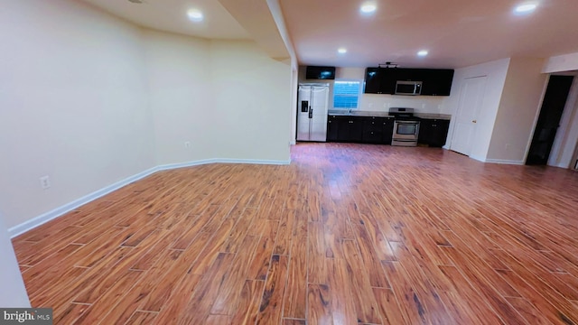 unfurnished living room with hardwood / wood-style flooring