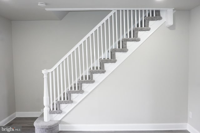 stairs with hardwood / wood-style flooring