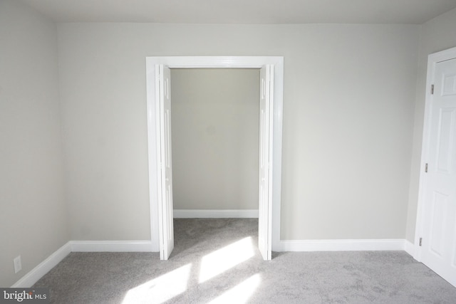 empty room featuring light carpet