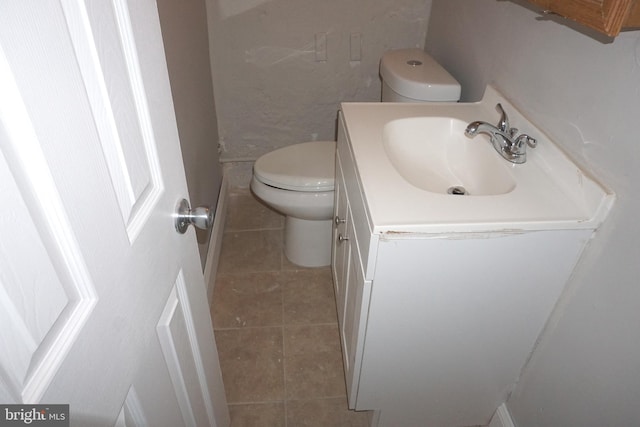 bathroom with tile patterned floors, vanity, and toilet