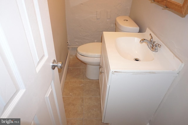 bathroom with vanity, tile patterned floors, and toilet