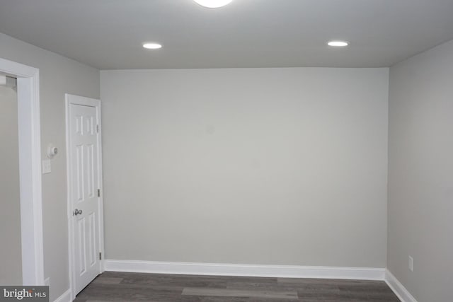 spare room with dark hardwood / wood-style floors