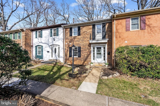 townhome / multi-family property with brick siding