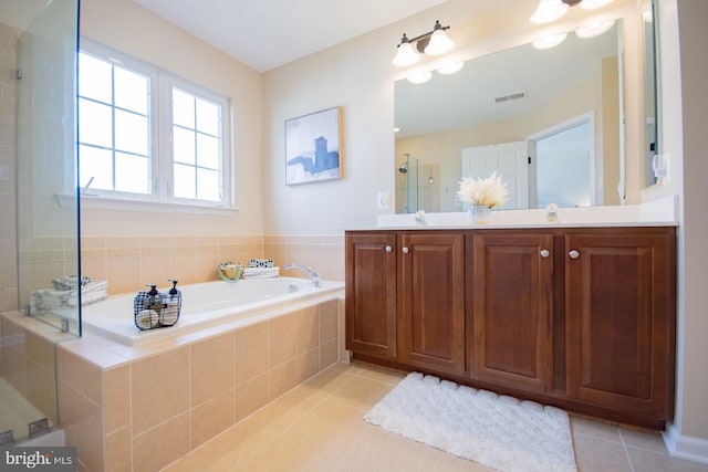 bathroom with vanity, plus walk in shower, and tile patterned flooring