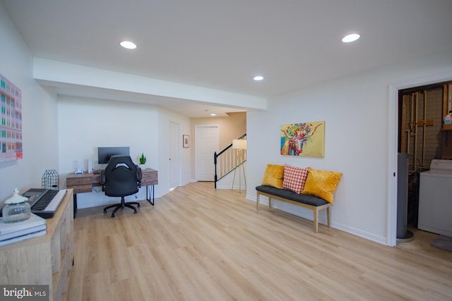 office area featuring washer / dryer and light hardwood / wood-style floors