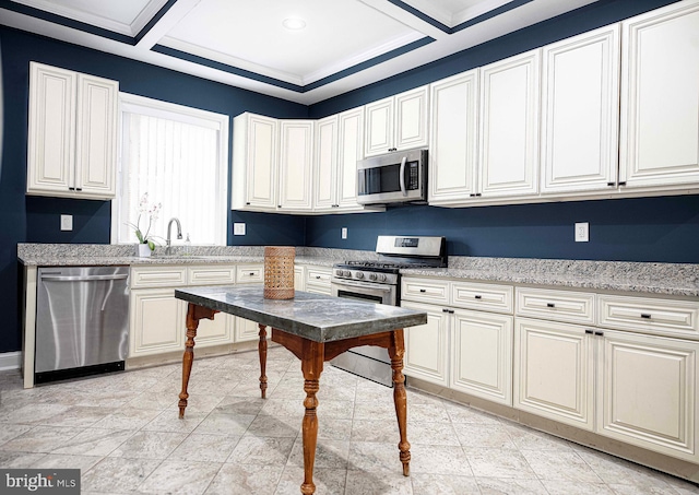 kitchen with sink, stainless steel appliances, light stone counters, coffered ceiling, and ornamental molding