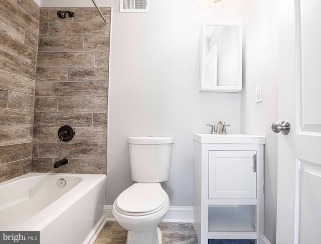 full bathroom with tiled shower / bath, vanity, and toilet