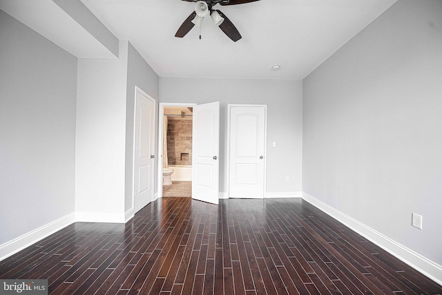 spare room with dark hardwood / wood-style flooring and ceiling fan