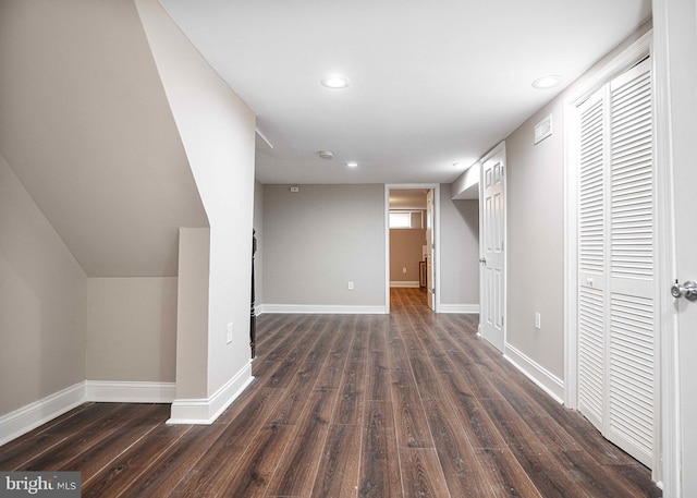 corridor with dark hardwood / wood-style flooring